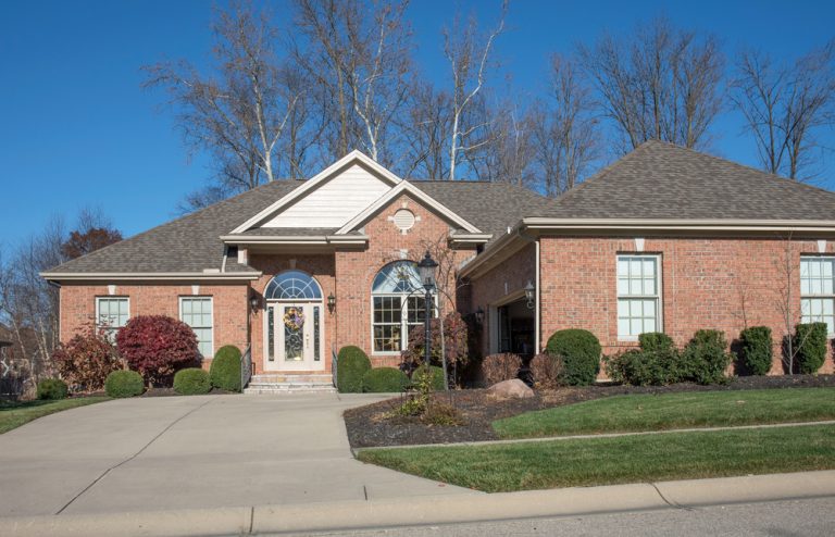 Landscape maintenance with trees trimmed with colorful flowers. Along the front sidewalk.
